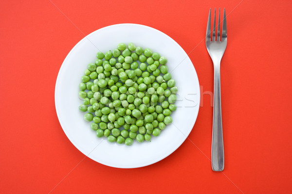 Green peas in plate Stock photo © erierika