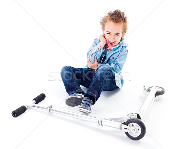 Boy with wounded ell near his scooter  Stock photo © erierika