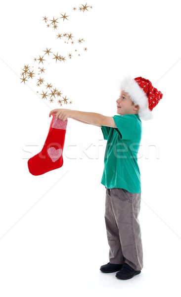 Joyful child releasing stars from Christmas stocking Stock photo © erierika