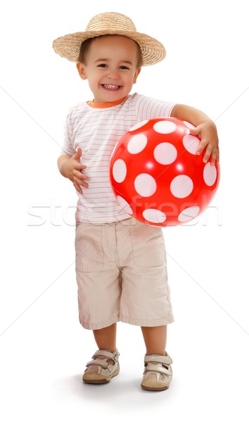 Cheerful little boy in straw hat, holding red dotted ball Stock photo © erierika