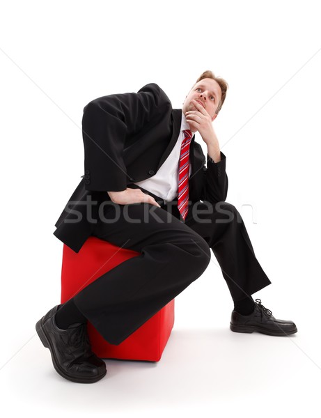 Businessman sitting on red tabouret Stock photo © erierika