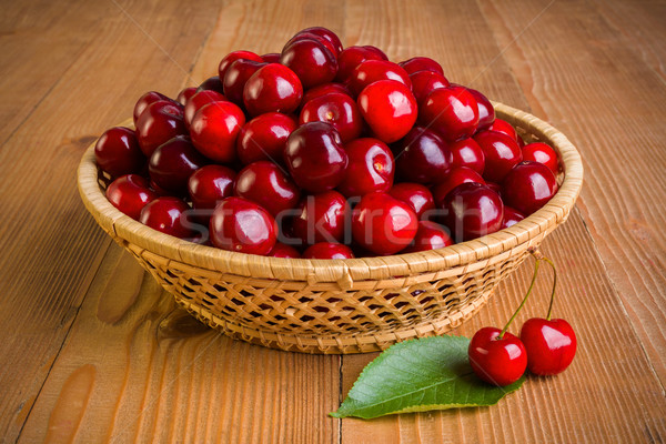 Sweet cherry berries (Prunus avium) in wicker plate Stock photo © erierika