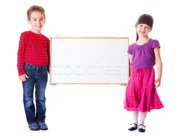 Cute girl and boy holding blank ad Stock photo © erierika