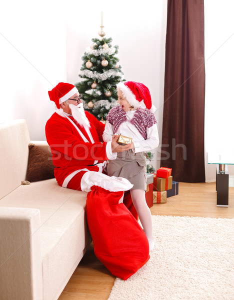Santa Claus giving gift to a teen girl Stock photo © erierika