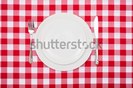 Empty white plates on checkered tablecloth Stock photo © erierika