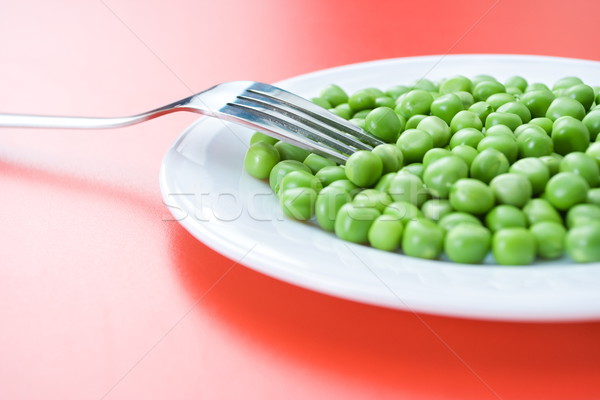 Green peas in plate Stock photo © erierika