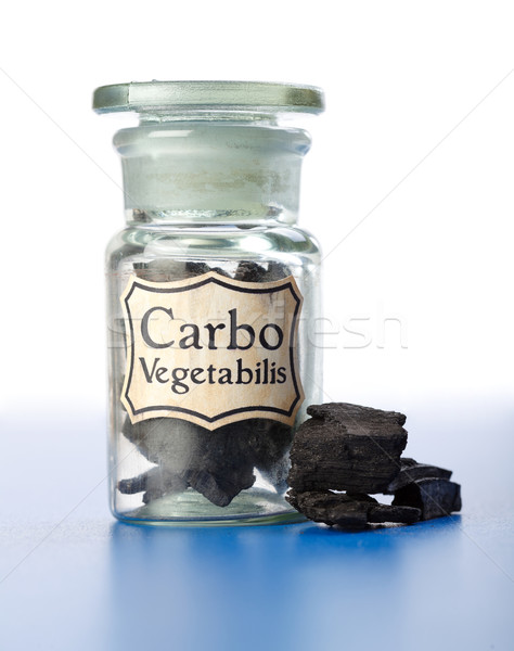 Carbo Vegetabilis, pure carbon in bottle and pieces Stock photo © erierika