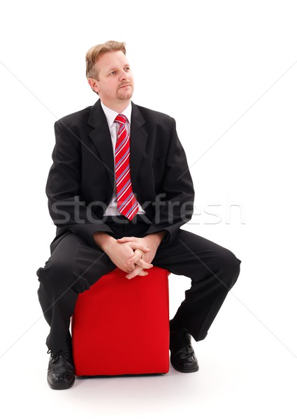 Businessman sitting on red tabouret Stock photo © erierika