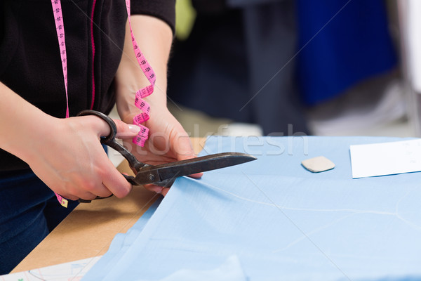 Cutting fabric with big old steel scissors Stock photo © erierika