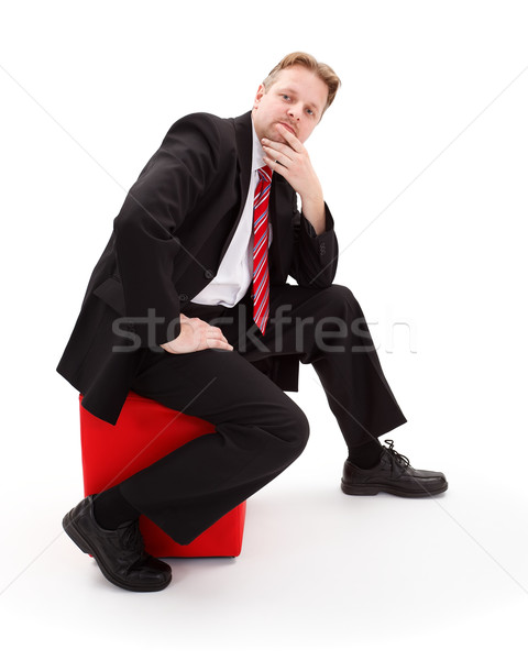 Thinking businessman sitting on tabouret Stock photo © erierika