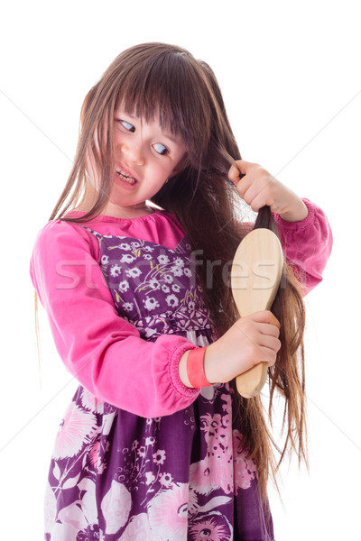 Little girl combing her frizzy hair Stock photo © erierika