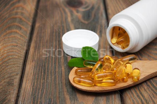 fish oil capsules in a spoon Stock photo © Es75