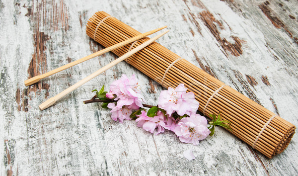 sakura branch and sticks on a bamboo mat Stock photo © Es75