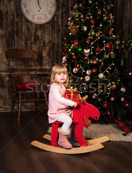 Kislány játék ló gyönyörű karácsonyfa lány Stock fotó © Es75