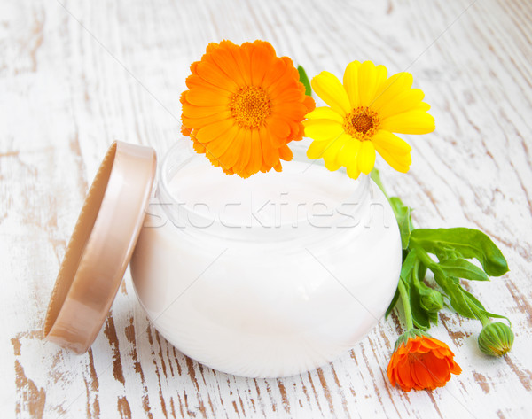 Face cream and calendula flowers Stock photo © Es75