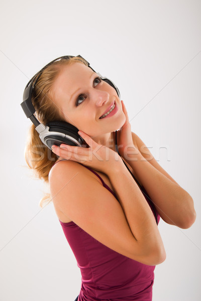 Stock photo: happy attractive girl in headphones listens to music