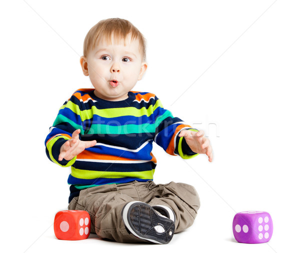 baby is playing with  toys over white background. Funny little k Stock photo © EwaStudio