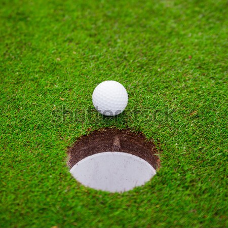 golf ball on lip of cup.  Stock photo © EwaStudio