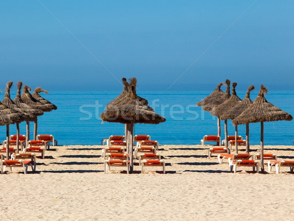 Tropical beach scenery with parasol and deck chairs.  umbrella a Stock photo © EwaStudio