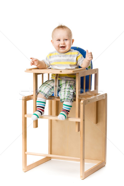 Baby sitting in highchair. Stock photo © EwaStudio