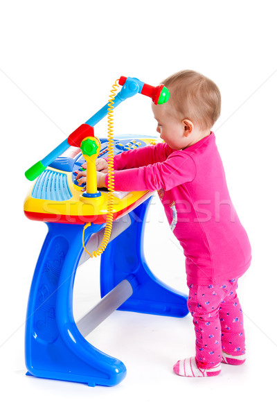 little girl and the keyboard on white background. funny girl. young DJ Stock photo © EwaStudio