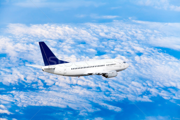 Airplane at fly on the sky with clouds Stock photo © EwaStudio