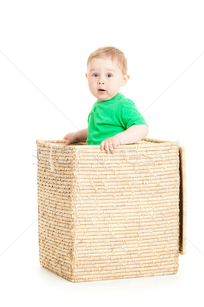 Stock photo: little boy inside a box on a white background 