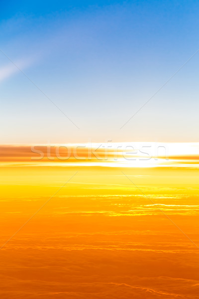 Stock photo: sunset above clouds. View of sunset  from airplane window 