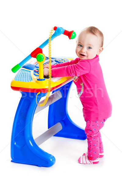 little girl and the keyboard on white background. funny girl. young DJ Stock photo © EwaStudio