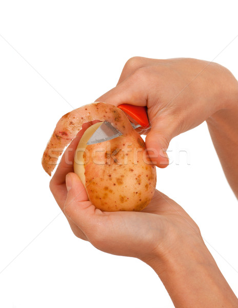Hand holding knife peeling potato  Stock photo © fanfo