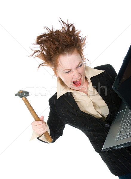  stressed businesswoman smashing her laptop with a hammer  Stock photo © fanfo
