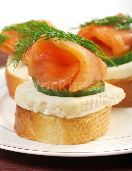 Canapes with smoked salmon  cheese and cucumber Stock photo © fanfo