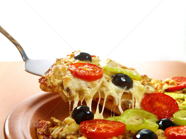 taking slice of pizza,melted cheese dripping Stock photo © fanfo
