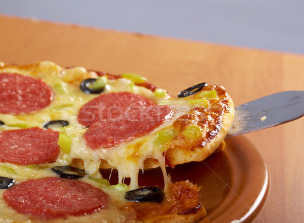 taking slice of pizza,melted cheese dripping Stock photo © fanfo