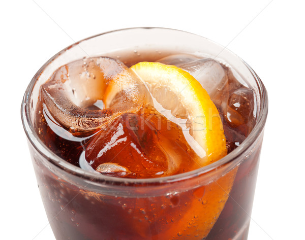Stock photo: Ice cube droped in cola glass