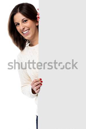 Beautiful young woman holding a blank sign Stock photo © fantasticrabbit