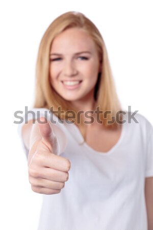 Smiling woman giving a thumbs up gesture Stock photo © fantasticrabbit