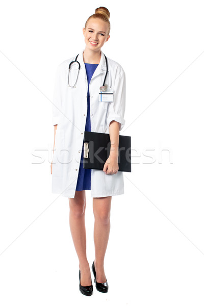 Smiling doctor holding a file of patient records Stock photo © fantasticrabbit