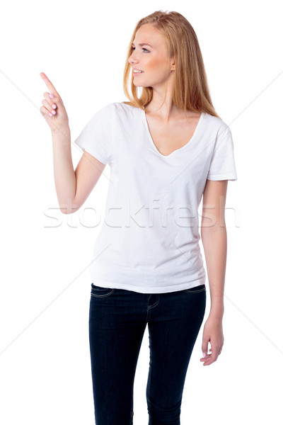 Woman pointing and looking at copyspace Stock photo © fantasticrabbit