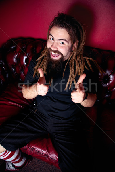 счастливым человека сидят диван указывая Сток-фото © fatalsweets