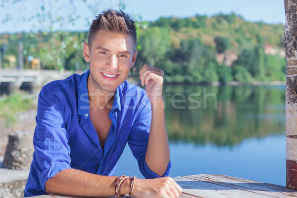 man at table near lake Stock photo © feedough