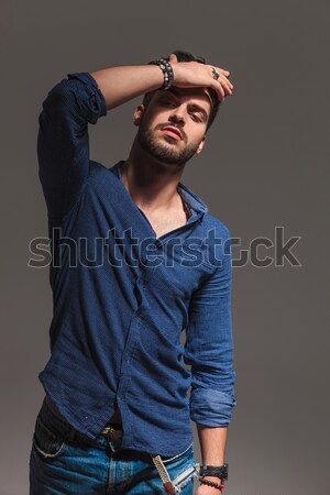  fashion man passing his hand through  his hair near girlfriend Stock photo © feedough