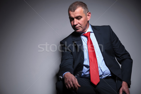 Middle aged business man looking down Stock photo © feedough