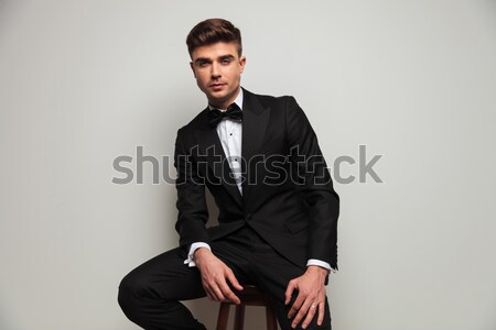Fiatalember öltöny nyakkendő visel szemüveg ül Stock fotó © feedough