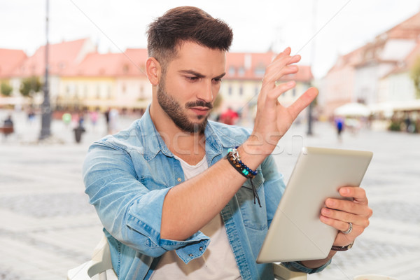 portrait of casual man checking his tablet in the city Stock photo © feedough