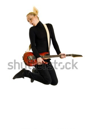 Stock photo: guitarist playing an electric guitar while jumping