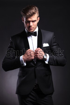 elegant man in suit and neck bow smoking a cigar  Stock photo © feedough