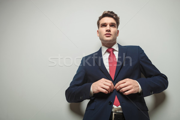 Young attractive business man closing his jacket  Stock photo © feedough