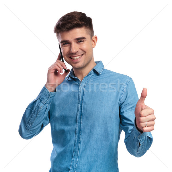 casual man talking on the phone and makes ok sign Stock photo © feedough