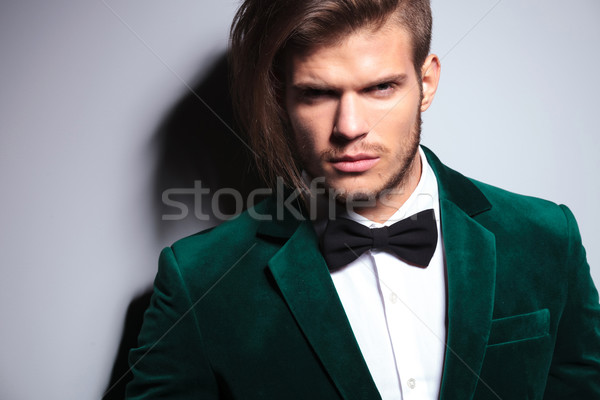  man with long hair wearing an elegant green suit and neck bow t Stock photo © feedough
